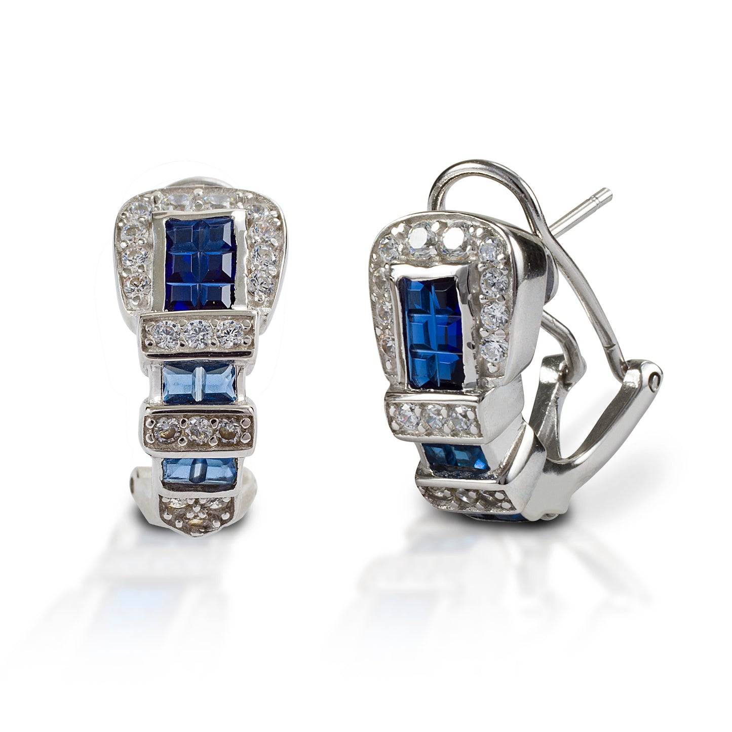 Western belt buckles for your ears! Kelly Herd Ranger Style Buckle Earrings are finely detailed replicas of a classic three piece western buckle set, enhanced with square sapphire stones. Available in white, or yellow 14k gold. Made with a French clip and post back. Features Western belt buckle style earrings. Blue and clear stones Available in white gold, or yellow gold Gold options feature diamonds and sapphires French clip and post back 8mm x 16mm