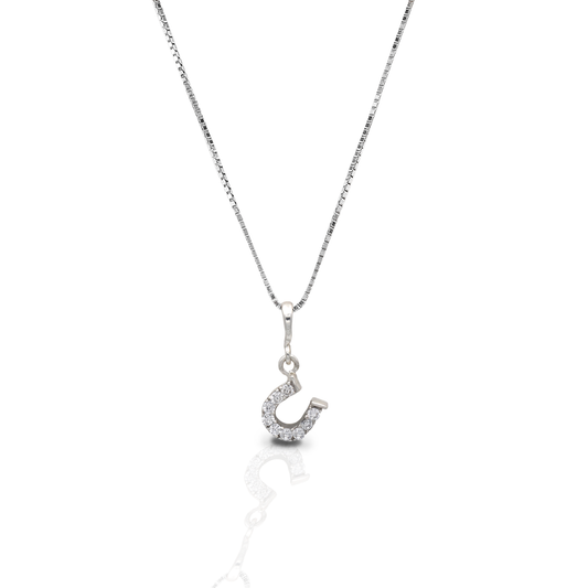 The Kelly Herd Clear Dangle Horseshoe Necklace features a beautiful offset sterling silver horseshoe pendant enhanced with clear CZ stones. Perfect for taking a little luck into the ring with you! Comes with 16-18" adjustable chain.  Features      Delicate horseshoe pendant.     Clear cubic zirconia stones     Sterling silver     Adjustable Chain     8mm x 8mm