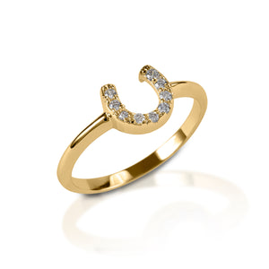 The Kelly Herd Clear Horseshoe Ring is a delicate gold ring enhanced with diamonds set in a horseshoe. Clean and understated, this ring is perfect for taking a little luck into the ring with you!  Features      Delicate horseshoe ring     Diamonds     Available in white gold, or yellow gold     Matching earrings and necklace available     8mm wide