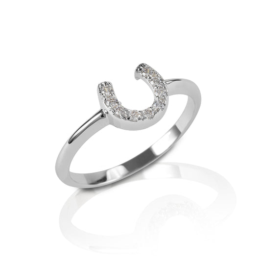 The Kelly Herd Clear Horseshoe Ring is a delicate gold ring enhanced with diamonds set in a horseshoe. Clean and understated, this ring is perfect for taking a little luck into the ring with you!  Features      Delicate horseshoe ring     Diamonds     Available in white gold, or yellow gold     Matching earrings and necklace available     8mm wide