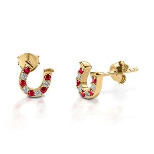 Kelly Herd Red & Clear Horseshoe Earrings are delicate gold horseshoes enhanced with rubies and diamonds. Perfect for taking a little luck into the ring with you!  Features      Delicate horseshoe earrings     Rubies and diamonds     Available in white, or yellow 14k gold     Matching ring and necklace available     8mm x 8mm
