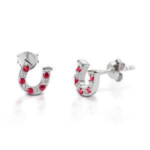 Kelly Herd Red & Clear Horseshoe Earrings are delicate sterling silver, or gold horseshoes enhanced with red and clear CZ stones. Perfect for taking a little luck into the ring with you!  Features      Delicate horseshoe earrings     Red and clear cubic zirconia stones     Sterling Silver     Matching ring and necklace available     8mm x 8mm