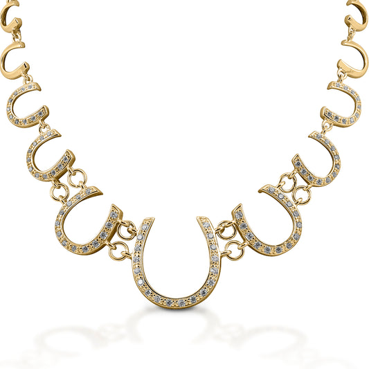The Kelly Herd Multi Horseshoe Necklace links progressively sized horseshoes, creating a lovely frame affect. The larger horseshoes are enhanced with diamonds.   Features      Linked horseshoe chain     Diamonds     14k Yellow Gold     22mm wide x 19''