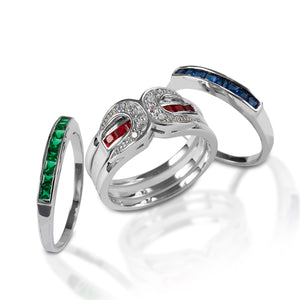     Horseshoe ring with interchangeable bands.     Comes with ruby, sapphire, and emerald bands     Can be worn with the horseshoe frame, alone, or stacked     10mm wide
