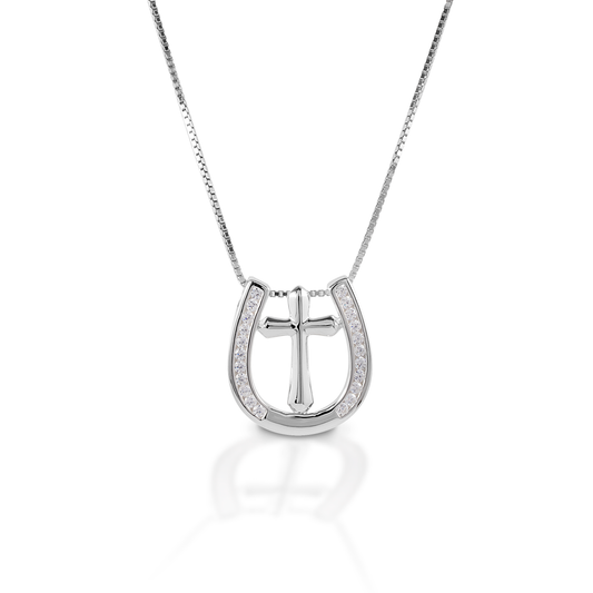 Sometimes all you need is faith and a little luck! The Kelly Herd Horseshoe Cross Necklace represents both. This simple, clean lined pendant has been crafted in sterling silver. The horseshoe is enhanced with clear CZ stones, and the cross is smooth. Comes with a 16-18" adjustable chain.  Features      Cross and horseshoe pendant     Clear cubic zirconia stones     Sterling Silver     18mm x 18mm