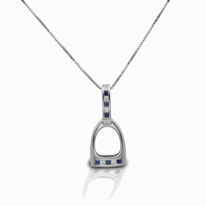 The Kelly Herd Blue & Clear Large English Stirrup Necklace is a perfect tiny replica of a classic English fillis stirrup. Made in sterling silver, the base of the stirrup and the stirrup "leathers" are enhanced with alternating blue & clear CZ stones. Comes with an adjustable 16-18" chain. 32 mm x 14 mm.