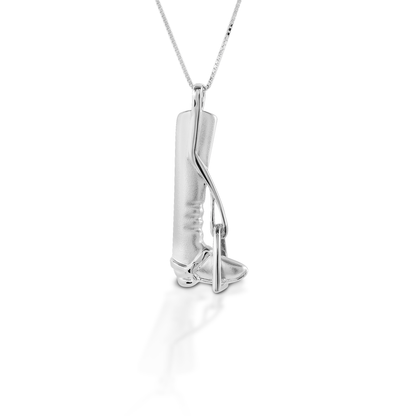 The Kelly Herd Tall Boot & Stirrup Necklace features the classic silhouette of a English tall boot; there is even a tiny spur strap! Made of sterling silver, this necklace would make an ideal gift for any English rider. Comes with a 16"-18" adjustable chain.  Features      Finely detailed English tall boot and stirrup pendant     Satin finish     Sterling Silver     Adjustable 16-18" chain     36mm x 14mm