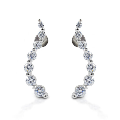 Kelly Herd Journey Earrings will be an elegant addition to your jewelry wardrobe. These stud earrings feature a curved line of graduated sized stones. Sterling silver with clear cubic zirconia stones. These earrings would make a perfect anniversary or graduation gift for a special someone!  Features      Elegant "journey" style earrings     Sterling silver with clear cubic zirconia stones     Stud backs     23mm x 4mm