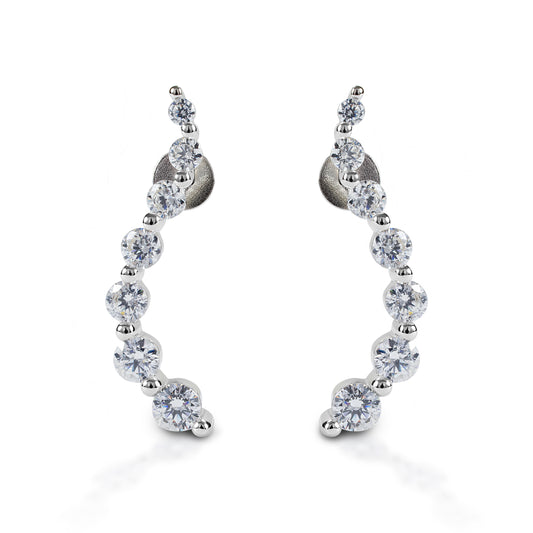Kelly Herd Journey Earrings will be an elegant addition to your jewelry wardrobe. These stud earrings feature a curved line of graduated sized stones. Sterling silver with clear cubic zirconia stones. These earrings would make a perfect anniversary or graduation gift for a special someone!  Features      Elegant "journey" style earrings     Sterling silver with clear cubic zirconia stones     Stud backs     23mm x 4mm