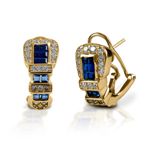Western belt buckles for your ears! Kelly Herd Ranger Style Buckle Earrings are finely detailed replicas of a classic three piece western buckle set, enhanced with square sapphire stones. Available in white, or yellow 14k gold. Made with a French clip and post back.  Features      Western belt buckle style earrings.     Blue and clear stones     Available in white gold, or yellow gold     Gold options feature diamonds and sapphires     French clip and post back     8mm x 16mm