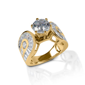Absolutely stunning! If you want a subtle equestrian touch on a true statement ring, then the Kelly Herd Horseshoe Solitaire Ring is for you. This gorgeous ring features a single round solitaire diamond, flanked by two horseshoes pavé set with emerald cut diamonds. Made in your choice of white or yellow gold.  Features      Statement ring with equestrian theme     White or Yellow gold with diamonds     Double horseshoes with pavé set diamonds     12mm wide