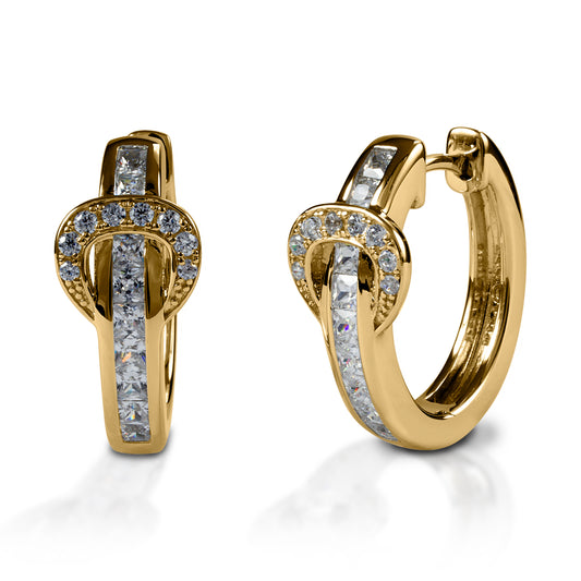 A fun take on classic hoop earrings! Kelly Herd Contemporary Buckle Earrings take the form of a simple show belt. Made of white or yellow gold, the "belt" is set with square pavé diamonds, while the "buckle" has round stones.  Features      Buckle and belt shaped hoop earrings     Diamonds     White or yellow gold     8mm x 17mm