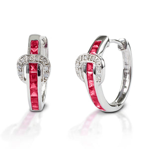 A fun take on classic hoop earrings! Kelly Herd Contemporary Buckle Earrings take the form of a simple show belt. Made of white or yellow gold, the "belt" is set with square pavé rubies and the "buckle" has round diamonds.  Features      Buckle and belt shaped hoop earrings     Rubies and diamonds     White or yellow gold     8mm x 17mm