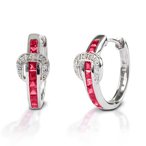 A fun take on classic hoop earrings! Kelly Herd Contemporary Buckle Earrings take the form of a simple show belt. Made of sterling silver, the "belt" is set with square pavé CZ, and the "buckle" has round red stones.  Features      Buckle and belt shaped hoop earrings     Red and clear Cubic Zirconia Stones     Sterling Silver     8mm x 17mm