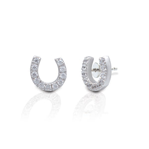 The smooth lines and offset mounting of these earrings produce an eye catching look. The Kelly Herd Offset Horseshoe Earrings are sure to dazzle with their polished sterling silver mounting and shimmering clear cubic zirconia stones. They are the perfect accent to even the most glamourous attire.    Features      Offset Horseshoe Design     Enhanced with Clear Cubic Zirconia Stones     Measures 8mm high and 8mm wide     Post Back     Sterling Silver