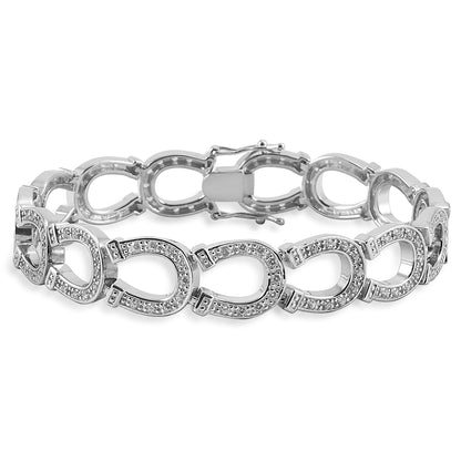 Forget about a tennis bracelet, an equestrian bracelet is much better! The Kelly Herd Horseshoe Bracelet is made of heel to toe linked horseshoes, all enhanced with clear cubic zirconia stones. Sterling Silver.  Features      Horseshoe chain bracelet     Sterling Silver     Clear CZ stones     12mm x 7 1/4''