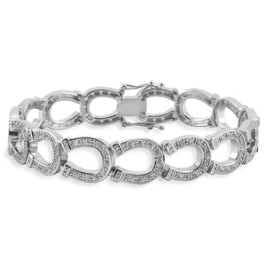 Forget about a tennis bracelet, an equestrian bracelet is much better! The Kelly Herd Horseshoe Bracelet is made of heel to toe linked horseshoes, all enhanced with diamonds. Available in your choice of white or yellow gold.  Features      Horseshoe chain bracelet     Available in white gold, or yellow gold     Diamonds     12mm wide x 71/4''