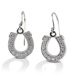 Kelly Herd Dangle Horseshoe Earrings feature horseshoe shaped drops on a hook style posts. Made in sterling silver with clear cubic zirconia stones.  Features      Horseshoe shaped earrings     Clear cubic zirconia stones     Sterling Silver     Hook style posts     12mm x 16mm