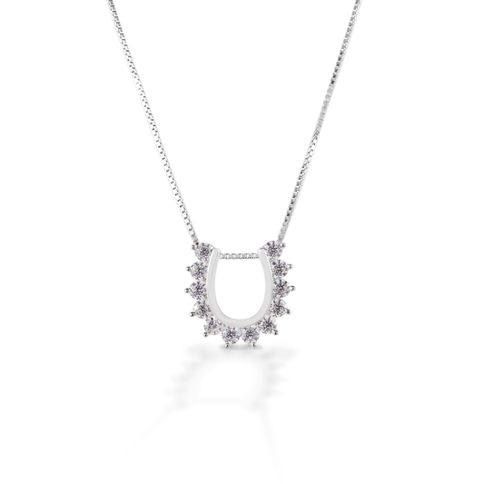 You wouldn't put this horseshoe on your horse, but it's awfully pretty! The Kelly Herd Horseshoe Necklace features a horseshoe shaped pendant with outside prong set cubic zirconia stones, creating a scalloped edge. Sterling Silver. Comes with adjustable 16-18" chain.  Features      Horseshoe pendant     Clear cubic zirconia stones     Sterling Silver     16-18" adj