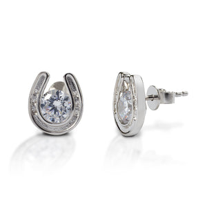 Stud earrings for horse lovers! Kelly Herd Horseshoe Stud Earrings feature cubic zirconia stones surrounded by sterling silver horseshoes. The horseshoes are so detailed you can see tiny little nails!  Features      Horseshoe earrings     Sterling silver with clear cubic zirconia stones     12mm x 8mm     Stud backs