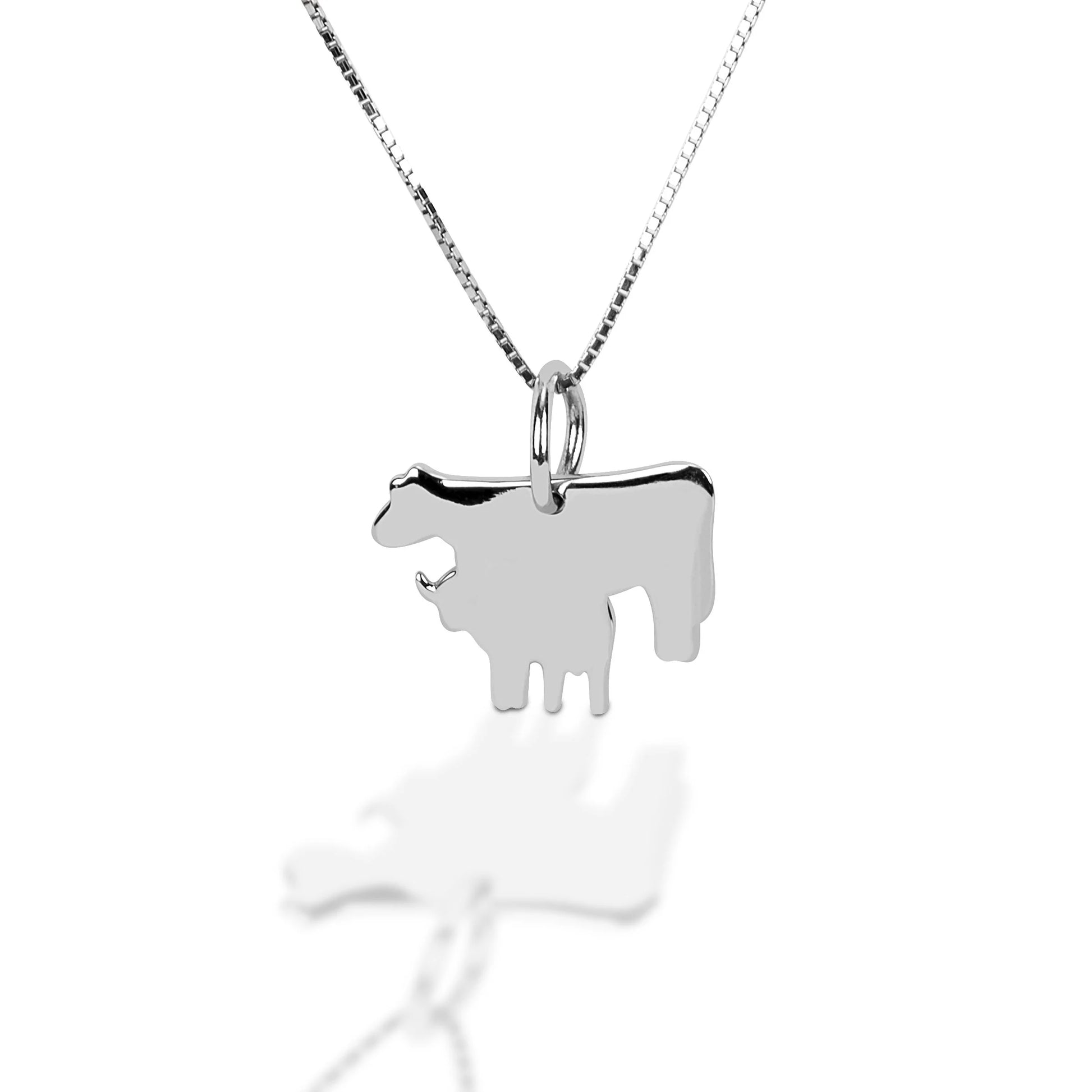 Nothing says family time like the bond between a mother and baby. This pendant is a great addition to our heifer collection. It can be worn along with any of our other pieces, or on its own.  With this necklace, you'll never forget your ranch roots.   Features      Heifer and Calf Design     16"-18" adjustable box chain with spring clasp     Sterling Silver     Measures 18 mm x 18 mm 