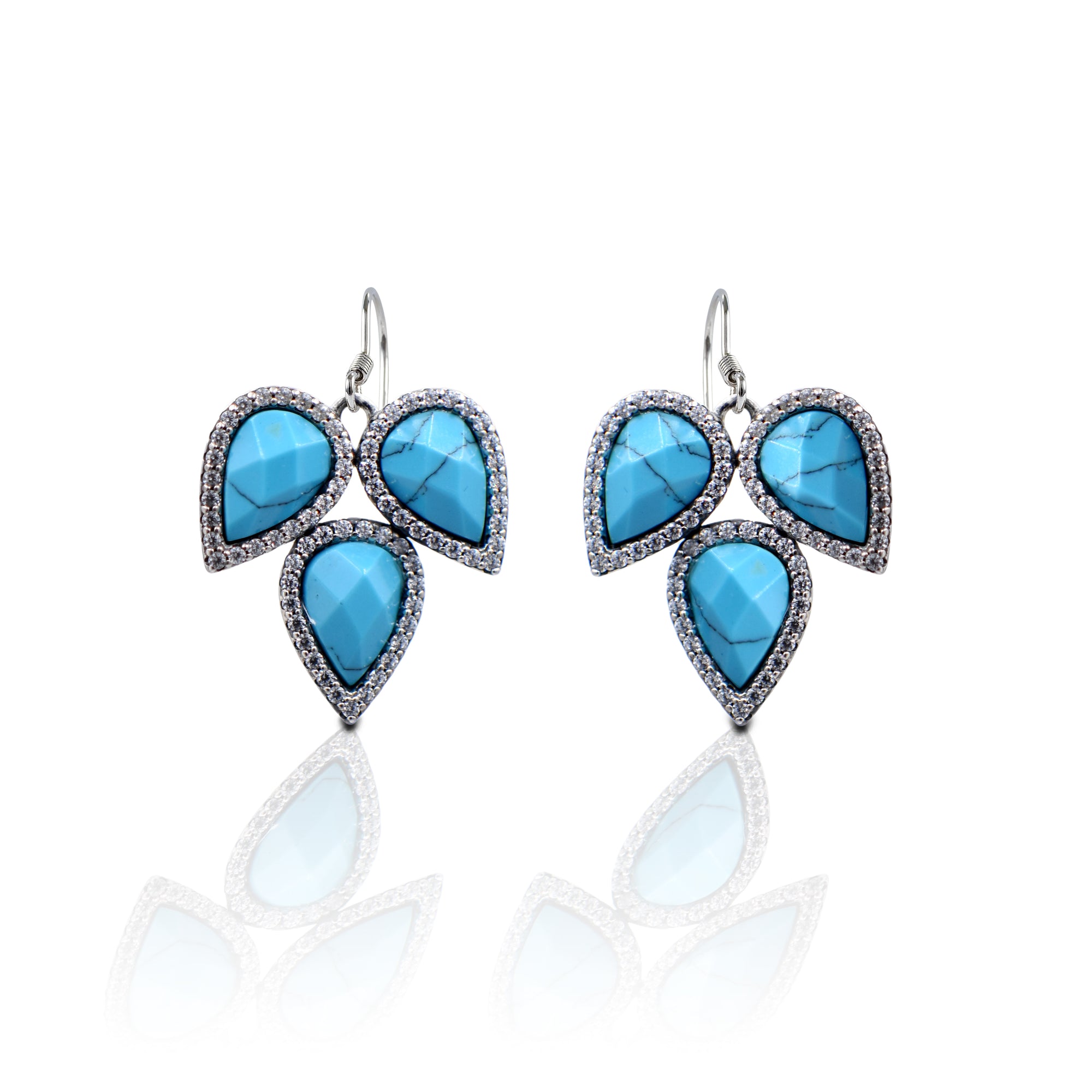 The Kelly Herd Three Teardrop Turquoise Hook Earrings have a unique Southwest appeal. They are a must have for anyone with a western sense of style. The turquoise details of the teardrops are accented with brilliantly sparkling cubic zirconia stones. These pair perfectly with the Kelly Herd Turquoise Teardrop Pendant Necklace.    Features      Western Teardrop Design     Enhanced with Clear Cubic Zirconia Stones     Dangle Hook Style     Sterling Silver     Measures 23mm high and 21mm wide