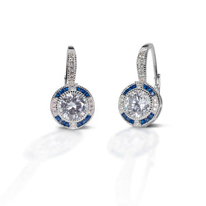 The simple but elegant look of the Kelly Herd Blue Spinel Halo Earrings is perfect for a causal evening on the town or in the show arena. These halo set earrings will make you the talk of the barn.  Features      Round cut cubic zirconia     Enhanced with blue spinel     Sterling Silver     Drop Backs