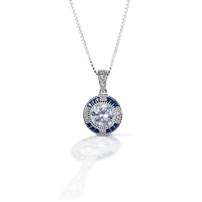 The simple but elegant look of the Kelly Herd Blue Spinel Halo Pendant is perfect for a causal evening on the town or in the show arena. This halo set pendant will make you the talk of the barn.  Features      Round cut cubic zirconia     Enhanced with blue spinel     Sterling Silver     Adjustable chain   