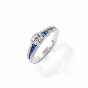 The Kelly Herd Blue Spinel Engagement Ring is absolutely lovely! With blue and white stones on the band, and a single clear solitaire, this is ring is classically beautiful, and yet just a bit more than you typically see with a solitaire ring. This ring would be a stunning engagement or promise ring! Made of sterling silver with blue and clear cubic zirconia stones.