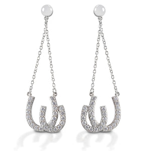 Kelly Herd Double Horseshoe Earrings are dramatic double horseshoe earrings enhanced with diamonds. The horseshoes hang on chains from post backs, giving them movement and the ability to catch the light. Available in your choice of white, or yellow 14k gold. Matching necklace is available.  Features      Dangle earrings with double horseshoes     Diamonds     Available in white gold, or yellow gold     Post backs     11mm x 38mm