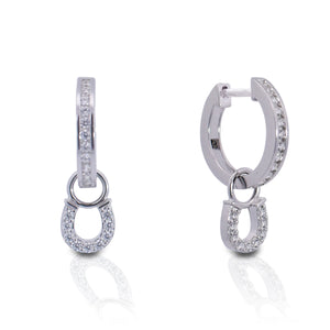 The Kelly Herd Hanging Horseshoe Earrings are the ultimate way to show your love for the equine world. Our Hanging Horseshoe Earrings feature a huggie style post with a hoop channel set earring. Perfect for everyday. The horseshoes will bring you and your horse good luck!  Features      Hanging Horseshoe Design      Enhanced with Clear Cubic Zirconia Stones     Huggie Style Closure      Sterling Silver     Measures 25 mm x 8 mm