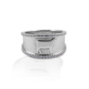 Perfect for Stock Show participants and 4H! The Kelly Herd Crystal Accent Heifer Ring features a 9mm wide band of brushed sterling silver with a raised edge of cubic zirconia stones.  In the center sits a perfectly formed tiny heifer.   Features      Wide brushed band     Raised cubic zirconia edge     Sterling silver     Raised heifer relief