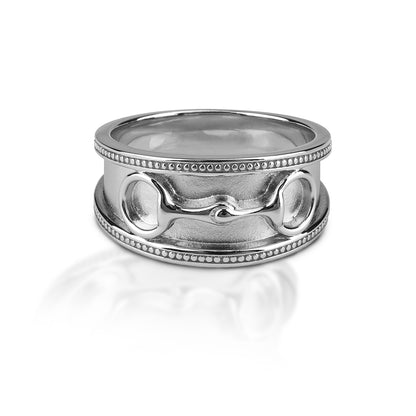 Perfect for the equestrian that prefers a ring without any bling! The Kelly Herd Wide Band Eggbutt Bit Ring features a 9mm wide band of brushed sterling silver with a raised beaded edge.  In the center sits a perfectly formed tiny Eggbutt bit.   Features      Wide brushed band     Raised beaded edge     Sterling silver     Raised eggbutt bit relief