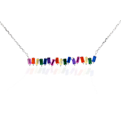 The Kelly Herd Multi-Color Bar Necklace is a must have for any jewelry collection. The baguette cut rainbow colored cubic zirconia stones are set in sterling silver featuring a 16"-18" adjustable chain, making this perfect for an easy layered style.   Features      Multi-Color baguette cut Cubic Zirconia stones     Lobster Clasp     Available in Sterling Silver