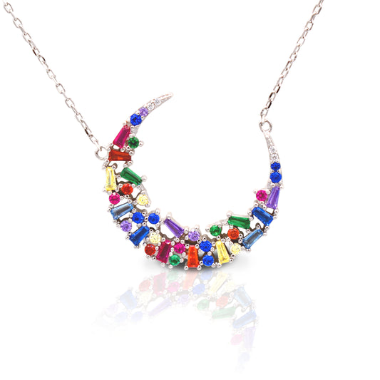The Kelly Herd Multi-Color Crescent Necklace is simply stunning. The baguette cut rainbow colored cubic zirconia stones are set in a sterling silver crescent moon shape. This necklace features a 16"-18" adjustable chain, making this perfect for any outfit.  Features      Multi-Color baguette cut Cubic Zirconia stones     Crescent Moon setting     Lobster Clasp     Available in Sterling Silver