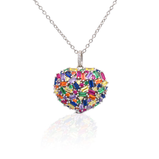 The Kelly Herd Multi-Color Heart Necklace is perfect to show your love. The baguette cut rainbow colored cubic zirconia stones are set in a sterling silver domed heart. This necklace features a 16"-18" adjustable chain, making this perfect for any outfit.  Features      Multi-Color Baguette & Round Cubic Zirconia stones     Domed Heart setting     Lobster Clasp     Available in Sterling Silver