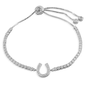 The Kelly Herd Bolo Bracelet combines a Western bolo tie closure with a horseshoe and a tennis bracelet to create something completely unique and beautiful! Made of sterling silver and clear cubic zirconia stones, this bracelet will add a touch of glamour to any outfit.  Features:      Tennis style bracelet with horseshoe motif     Bolo tie closure     Sterling silver     Clear cubic zirconia