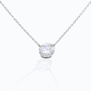 The Kelly Herd Clear Stone Naked Pendant features a 3CT clear cubic zirconia stone, that free floats on the sterling silver chain. This necklace is sure to catch everyone's eye as it shimmers in the light. This necklace features a 16"-18" adjustable chain, making it perfect to wear with any outfit.  Features      3 CT Clear Cubic Zirconia     Free Floating Stone     Matching Earrings Available     Available in Sterling Silver