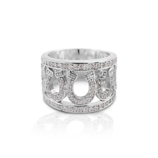 Lucky 7 and Lucky Horseshoes! The Kelly Herd Seven Horseshoe Ring is bold and bright and going to get noticed. Available in your choice of white, or yellow 14k gold. Enhanced with diamonds.  Features      Multiple horseshoe ring     Enhanced with diamonds     Available in white, or yellow 14k gold     14mm wide