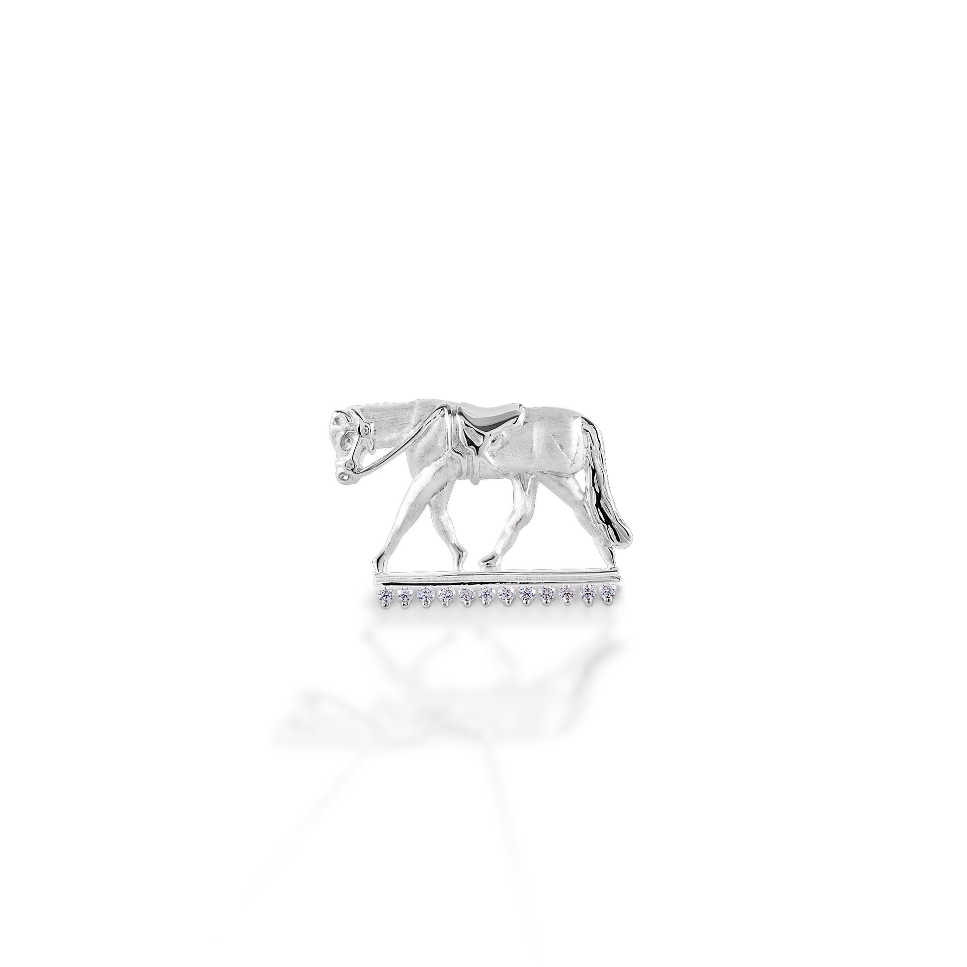 Wear your sport proudly! The Kelly Herd English Horse Pendant features a finely detailed trotting horse in English tack. Made in brushed 14K gold, with the "ground" enhanced with diamonds.  Features      English horse pendant     Enhanced with diamonds     Available in 14K gold     27mm x17mm