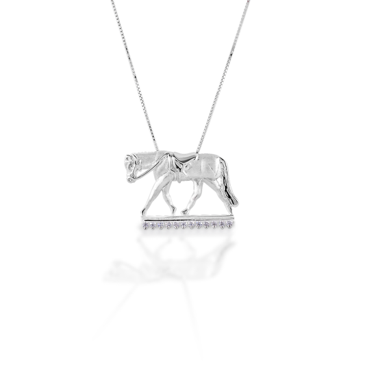 Wear your sport proudly! The Kelly Herd English Horse Necklace features a finely detailed trotting horse in English tack. Made of brushed sterling silver with the "ground" enhanced with clear CZ stones. Comes with adjustable 16-18" chain.  Features      English horse pendant     Enhanced with clear CZ stones     Sterling Silver     Adjustable 16-18" chain     27mm x 17mm   