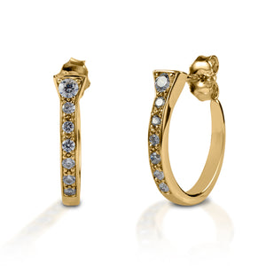 Kelly Herd Horseshoe Nail Earrings offer a classic hoop earring style, with an equestrian nod. Made of white or yellow gold horseshoe "nails" enhanced with diamonds these earrings will complement almost any fashion style. Post back.  Features      Horseshoe nails curved into a hoop style     Diamonds     Available in white, or yellow 14k gold     Hoop with post back     5mm x 19mm