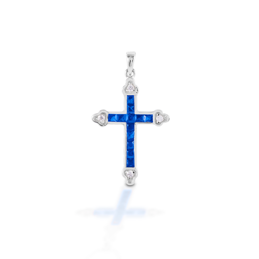 The Kelly Herd Blue Cross is a traditional St. Thomas style cross fashioned in 14K gold with sapphires and diamonds.  Features      Traditional cross pendant     Blue and clear stones     Available in 14K gold with sapphires and diamonds     29mm x 21mm