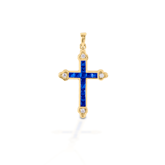 The Kelly Herd Blue Cross is a traditional St. Thomas style cross fashioned in 14K gold with sapphires and diamonds.  Features      Traditional cross pendant     Blue and clear stones     Available in 14K gold with sapphires and diamonds     29mm x 21mm