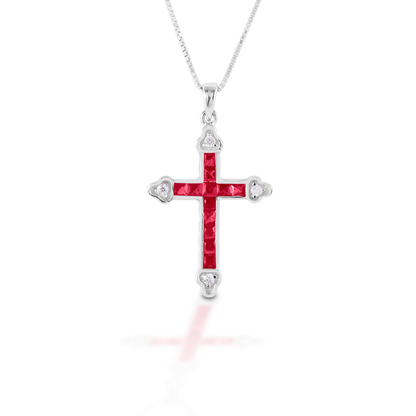 The Kelly Herd Red Cross is a traditional St. Thomas cross fashioned in sterling silver with red and clear CZ stones. Comes with an adjustable 16-18" chain.  Features      Traditional cross pendant     Red and clear cubic zirconia stones     Sterling Silver     Comes with adjustable 16-18" chain     29mm x 21mm