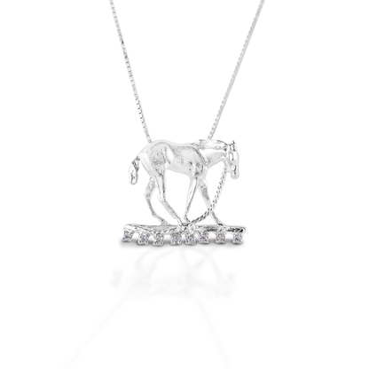The Kelly Herd Foal & Halter Pendant perfectly captures a moment in the life of a foal, "what is this halter thing they have put on me?!" Beautifully crafted in your choice in sterling silver. Comes with 16-18" adjustable chain.  Features      Foal pendant     Enhanced with clear CZ stones     Sterling Silver     Comes with adjustable 16-18" chain     32 mm x 28 mm