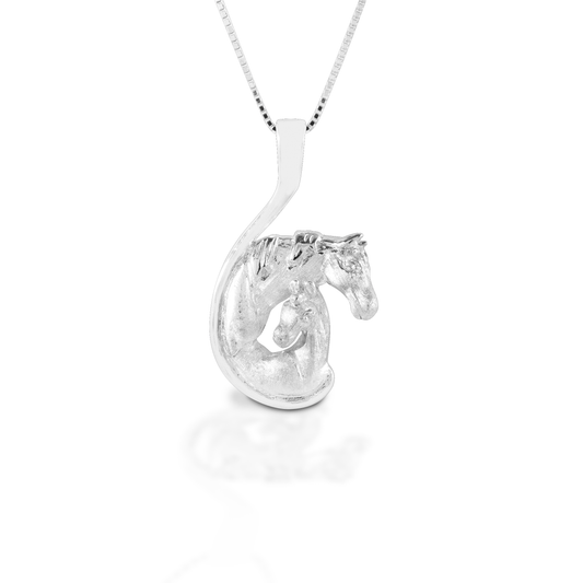 The Kelly Herd Mare and Foal Necklace celebrates equine motherhood. This lovely pendant is made of sterling silver with a satin finish. The enveloping curve of the pendant represents the unbreakable bond of a mother's love. Perfect for Mother's Day or as a baby gift - either human or equine! Comes with a 16"-18" adjustable chain.  Features      Mare and foal pendant     Sterling Silver     Comes with adjustable 16-18" chain     24mm x 41mm