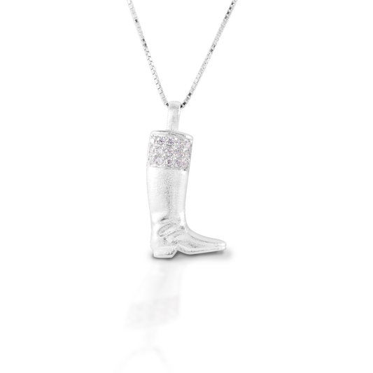 The Kelly Herd English Boot Necklace features a traditional style English boot made of brushed sterling silver and enhanced with CZ. It brings to mind fox hunts, and jockeys and cavalry officers. Comes with a 16"-18" adjustable chain.  Features      English boot pendant     Enhanced with clear CZ stones     Sterling Silver     Comes with adjustable 16-18" chain