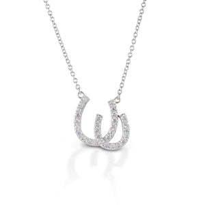 Have double the luck with the Kelly Herd Double Horseshoe Necklace. This sterling silver and CZ pendant features two overlapping horseshoes enhanced with CZ. Comes with a 16"-18" adjustable chain.  Features      Double Horseshoe pendant     Sterling Silver     Clear cubic zirconia stones     15 mm x13 mm