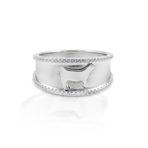 Perfect for Stock Show participants and 4H! The Kelly Herd Crystal Accent Steer Ring features a 9mm wide band of brushed sterling silver with a raised edge of cubic zirconia stones.  In the center sits a perfectly formed tiny steer.   Features      Wide brushed band     Raised cubic zirconia edge     Sterling silver     Raised steer relief